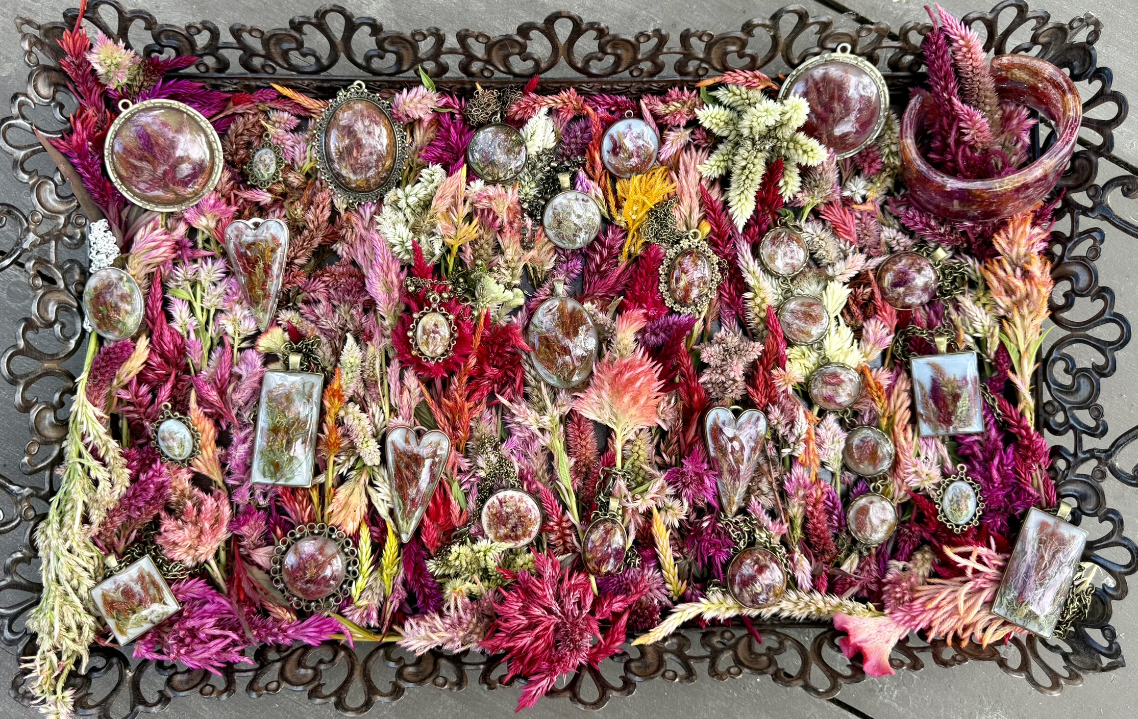 Floral Alchemy pieces resting in celosia blooms